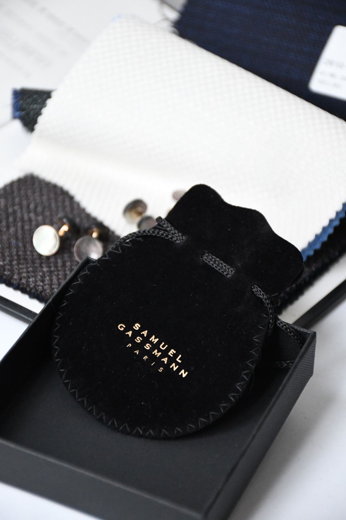 Black circular cufflinks by Samuel Gassmann x Ardentes Clipei, featuring sleek design and polished finish for men's formal wear.