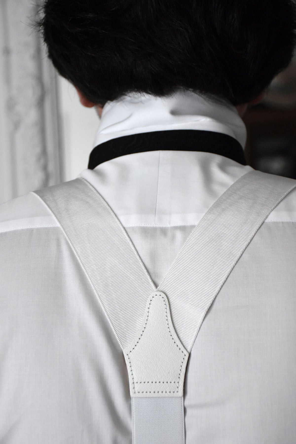White moiré suspenders by Albert Thurston with adjustable straps, styled as classic men's accessory.