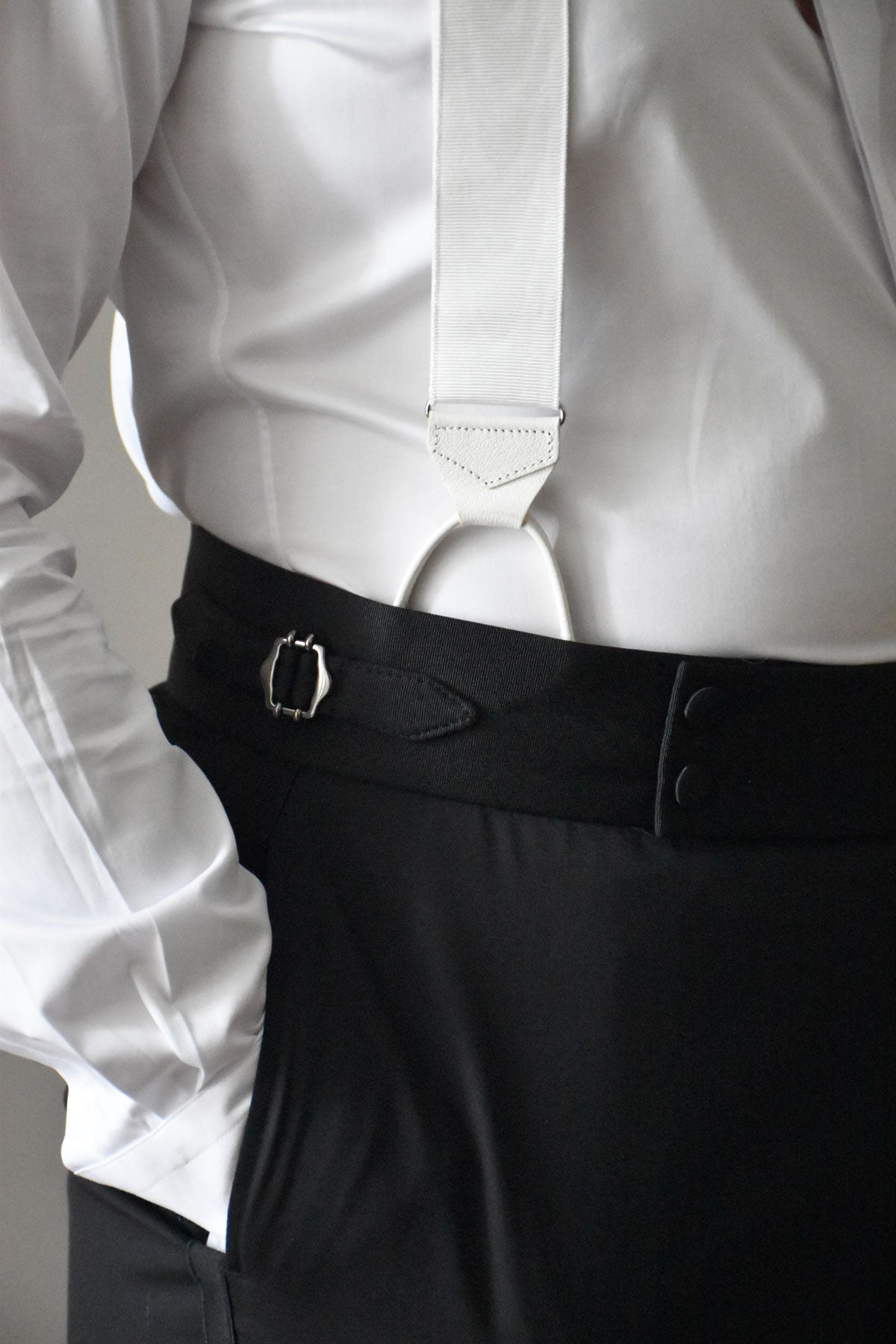 White moiré suspenders by Albert Thurston with adjustable straps and silver-toned hardware.