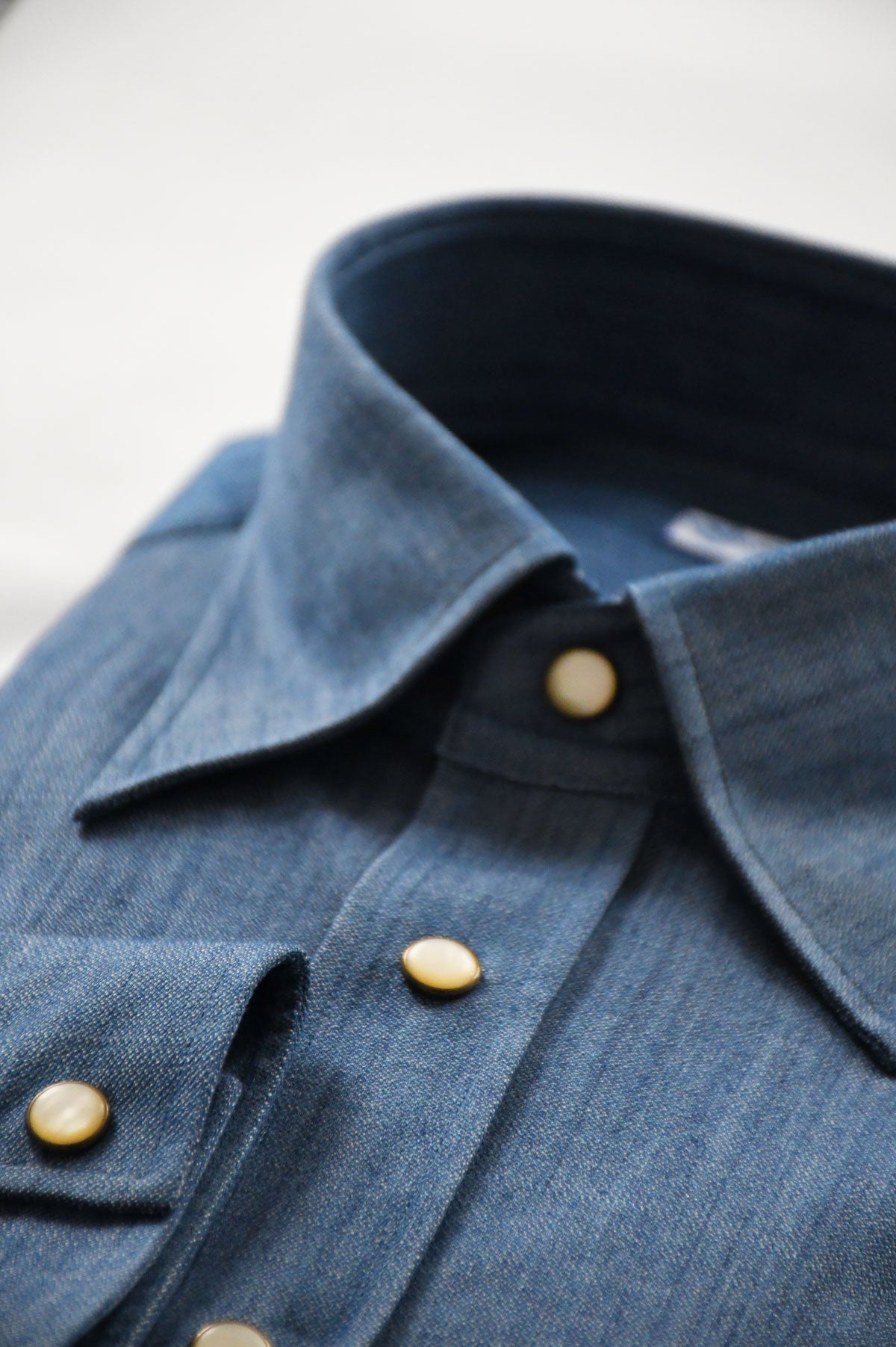 Blue denim Western chemise shirt by Ardentes Clipei with classic Western style and button-down front.