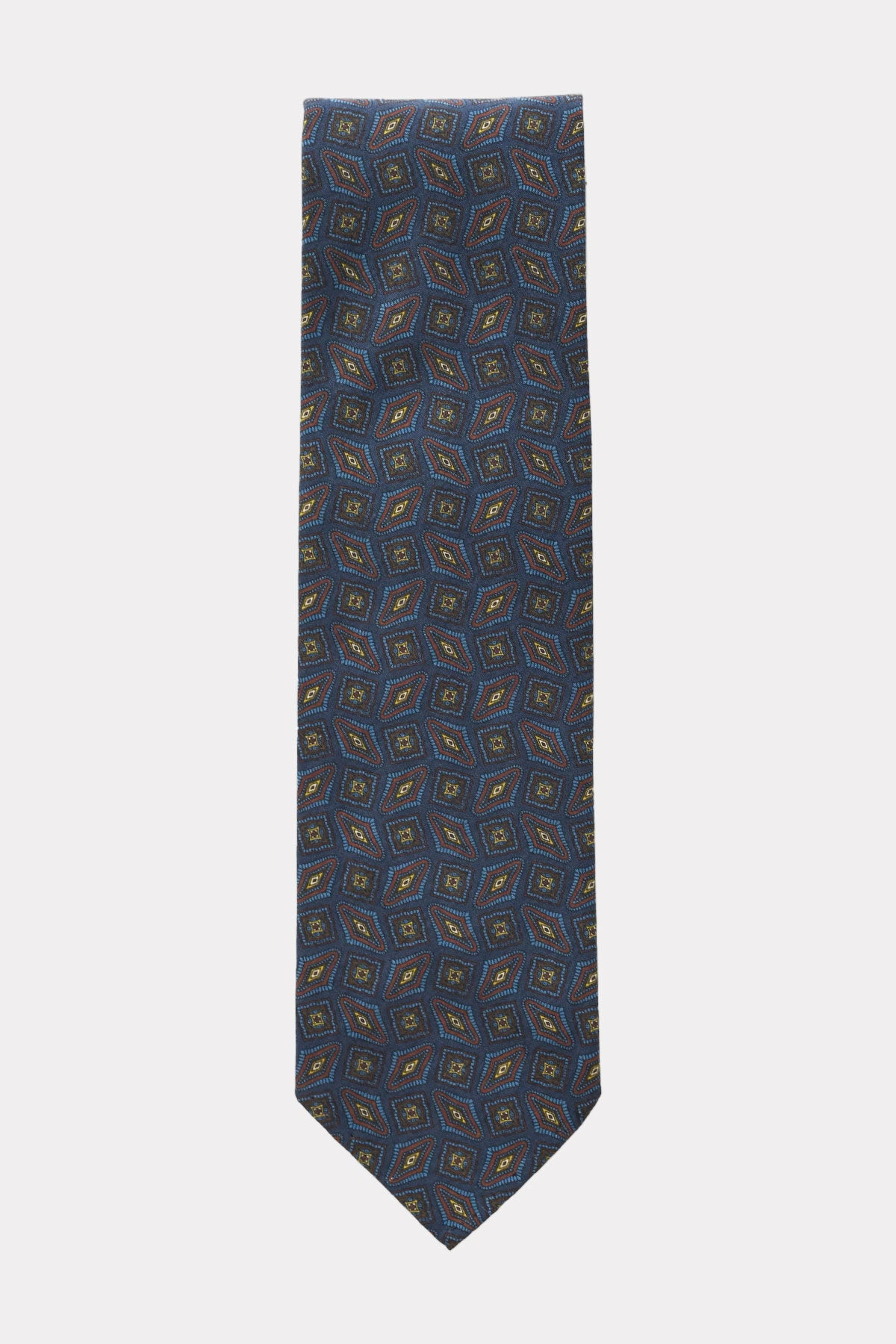 Blue tie with geometric brown and yellow pattern, designed by Ardentes Clipei, visible with detailed fabric and stylish design.