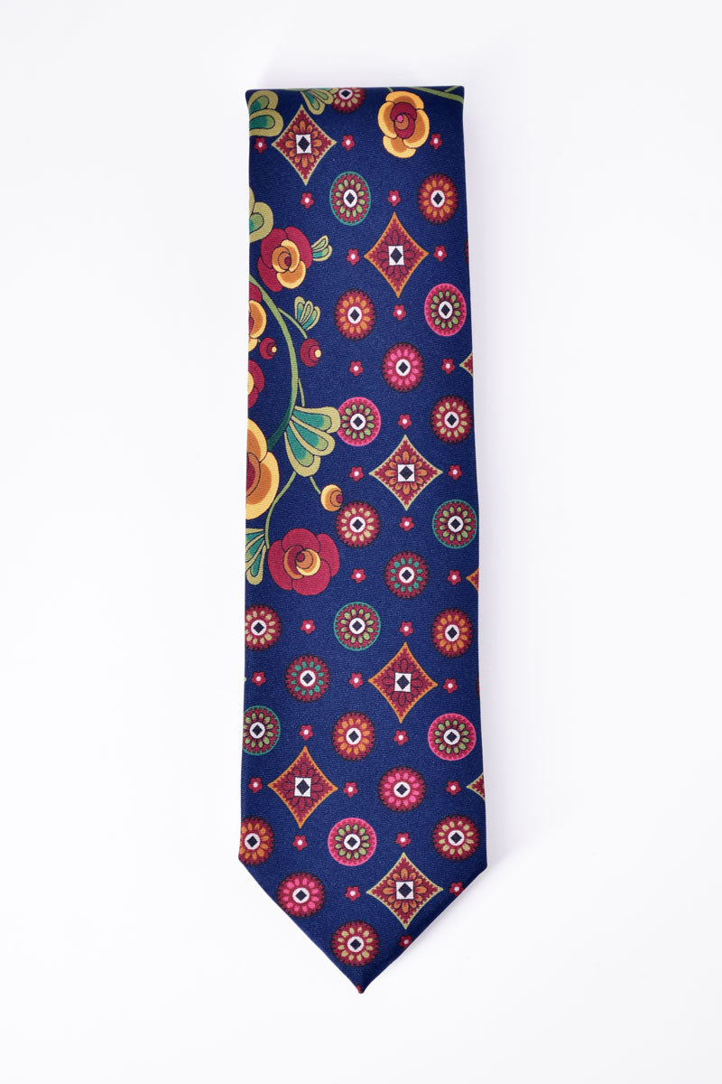 Navy blue Ardentes Clipei tie featuring geometric and floral patterns, showcasing intricate design and elegant fabric detail.