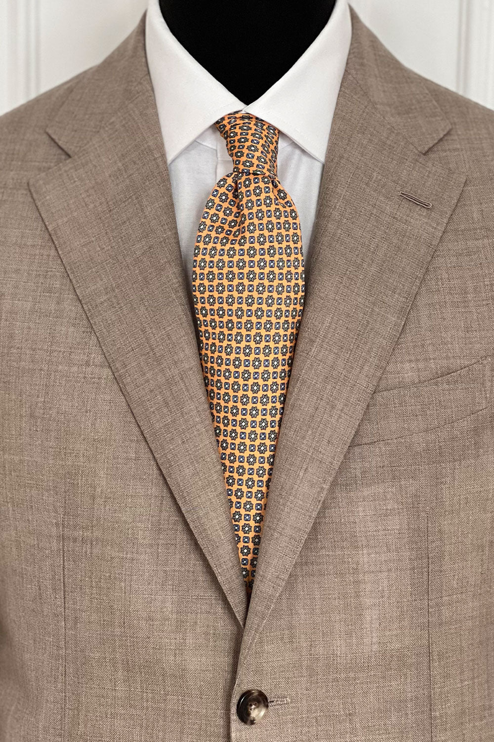 Orange pastel floral motif cravate by Ardentes Clipei featuring a elegant, colorful design on smooth fabric.