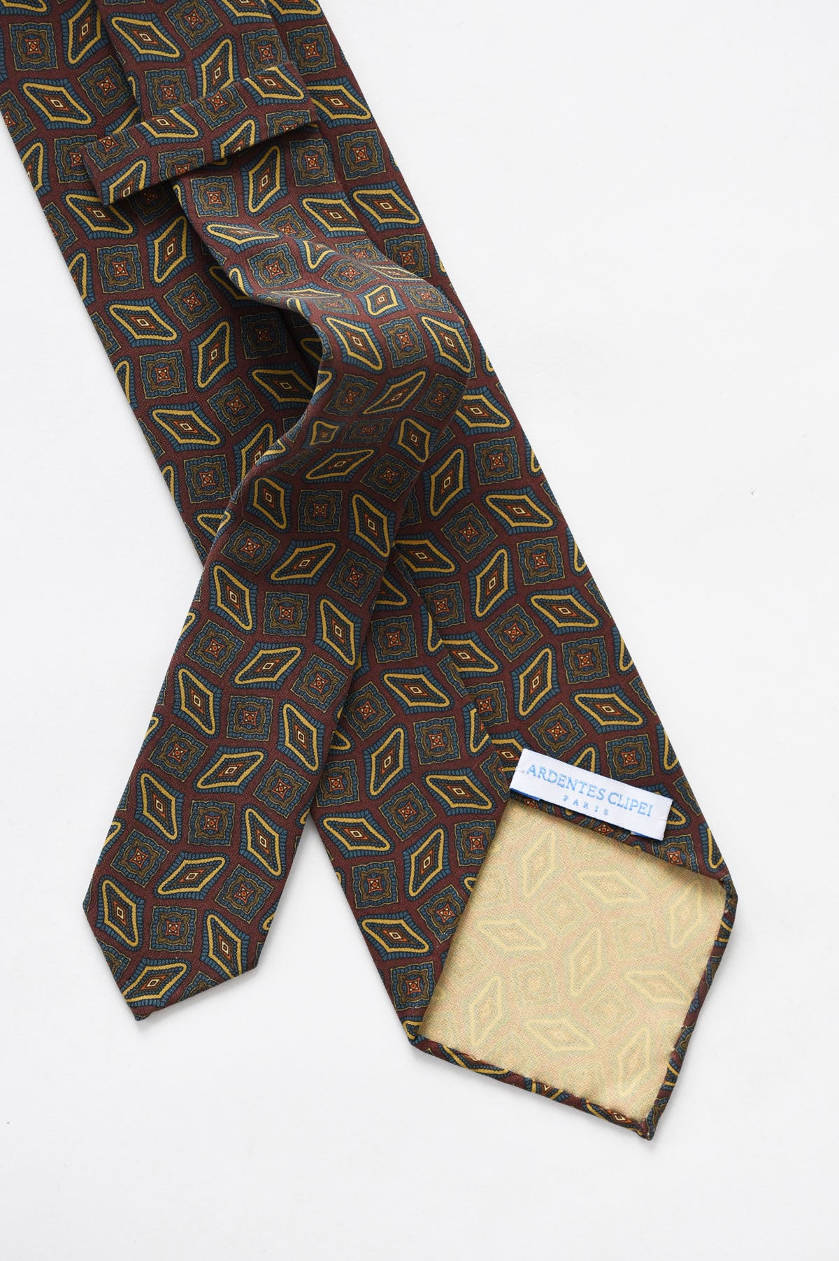 Brown tie with blue and beige geometric pattern by Ardentes Clipei, showcasing the detailed fabric design.