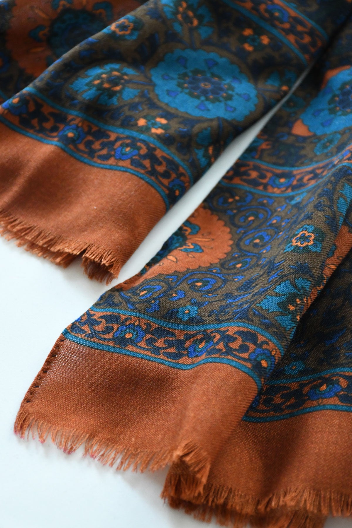 Orange ocre botanical motif scarf from Ardentes Clipei, lightweight and stylish, showcased in a close-up image.