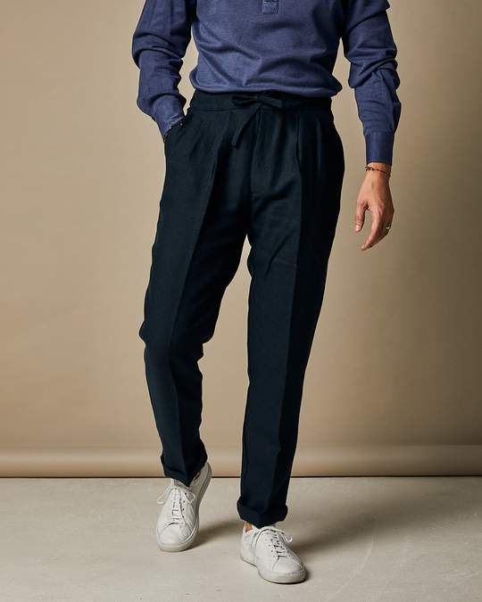 Maritime blue linen casual pants by Ardentes Clipei with drawstring waist, Irish-inspired design, styled for relaxed wear.