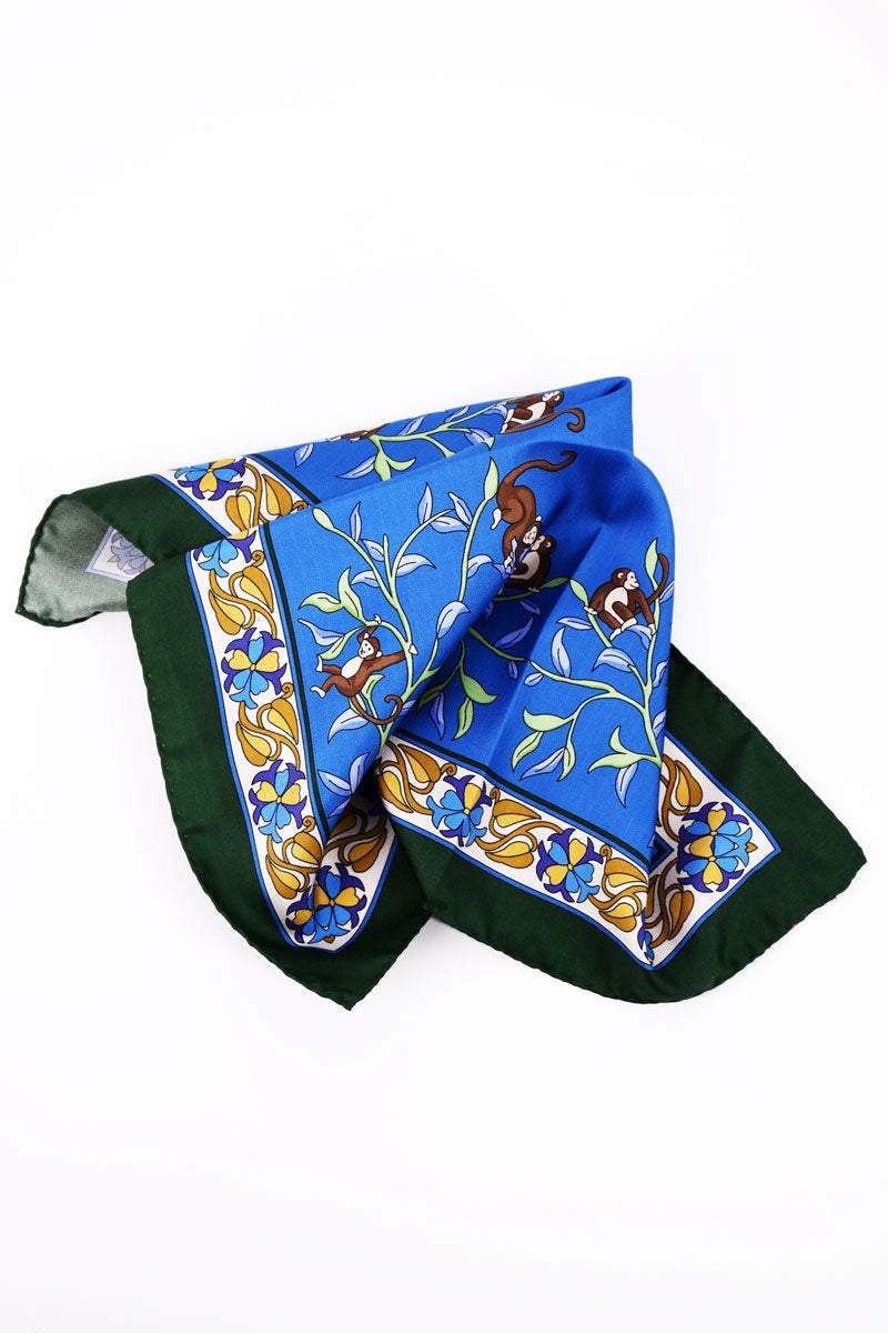 Blue silk pochette with monkey motif by Ardentes Clipei, featuring a stylish and intricate design.