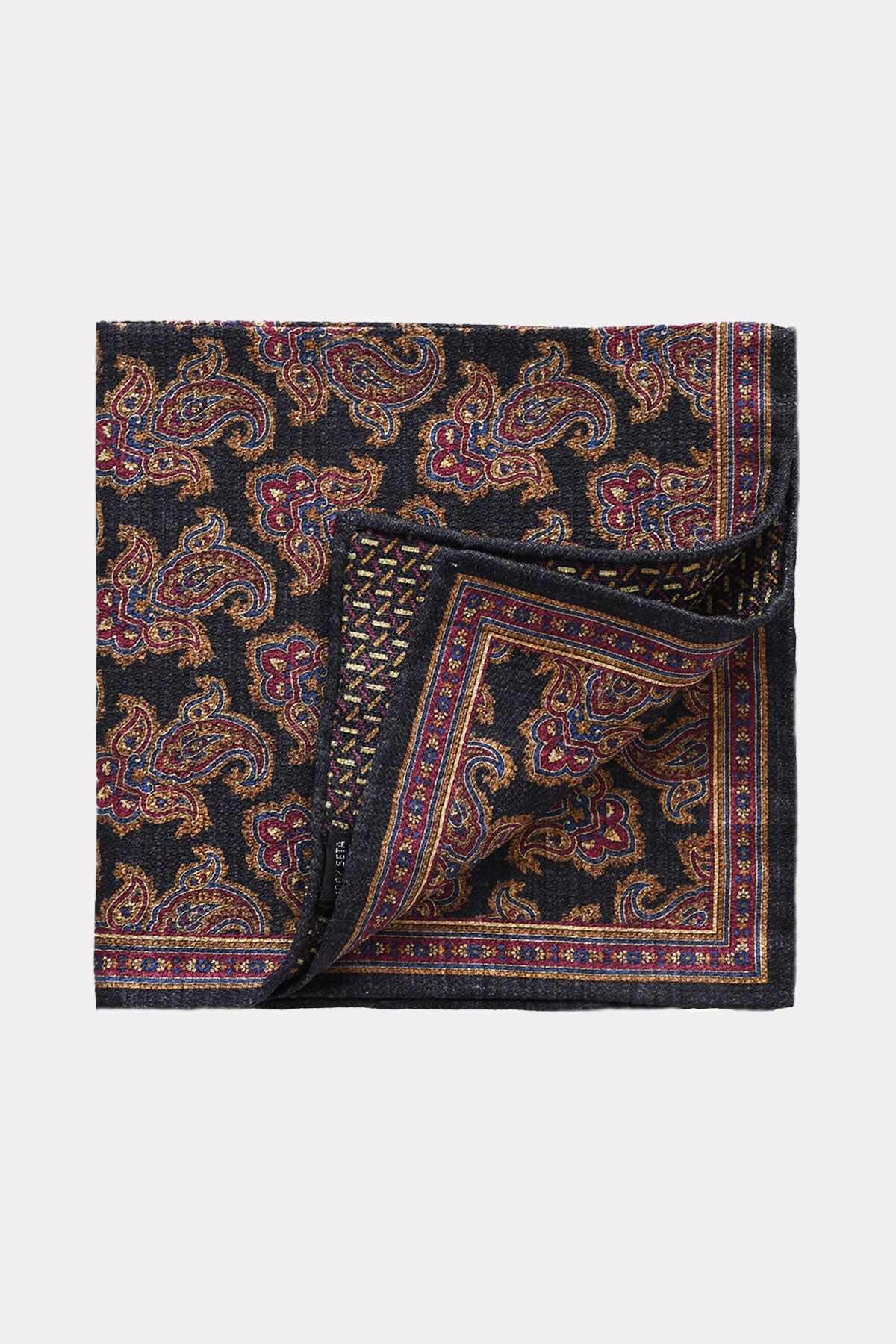 Reversible blue navy pochette by Ardentes Clipei with a paisley pattern, showcasing elegant fabric and versatile style.