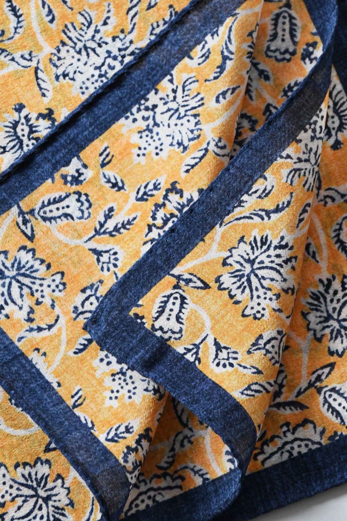 Yellow floral motif pochette by Ardentes Clipei, featuring a vibrant design and compact, elegant style for accessories.
