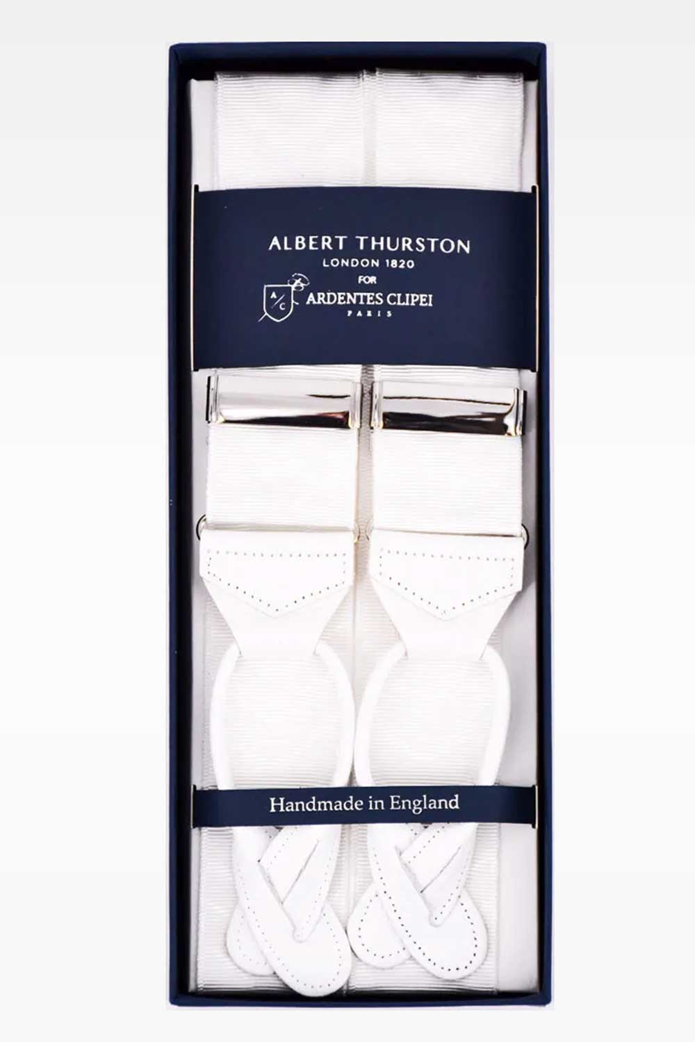 White moiré suspenders by Albert Thurston featuring adjustable straps and classic design, worn over a dress shirt.
