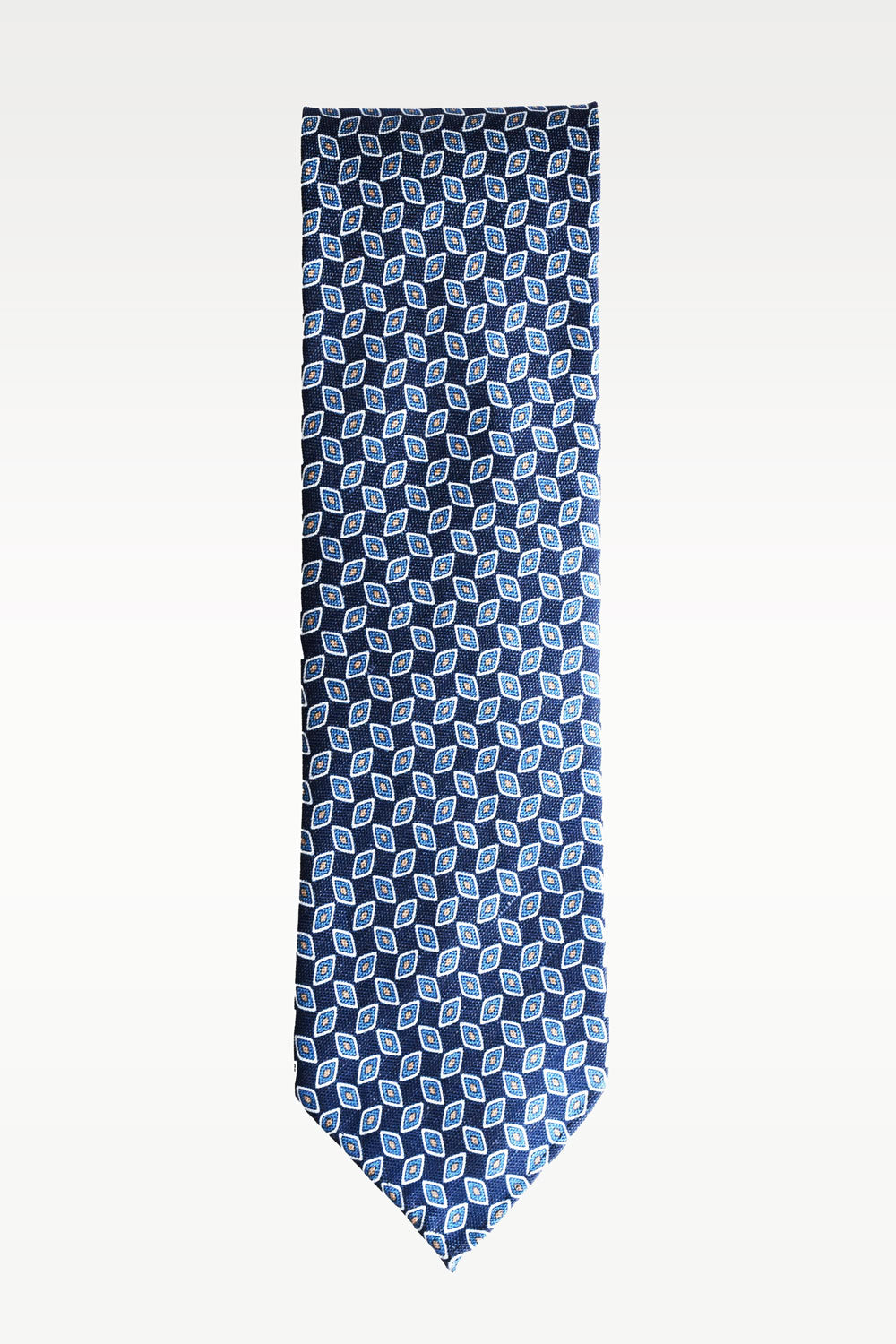 Blue geometric patterned silk and linen tie by Ardentes Clipei, showcasing a stylish, intricate design on smooth fabric.
