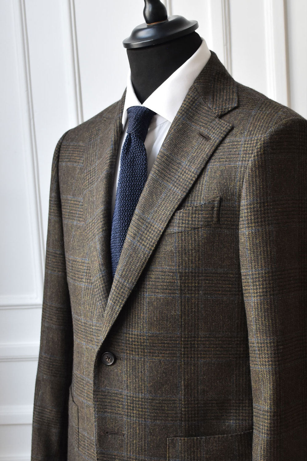 Blue knit tie by Ardentes Clipei featuring a textured pattern, ideal for adding a sophisticated touch to formal outfits.