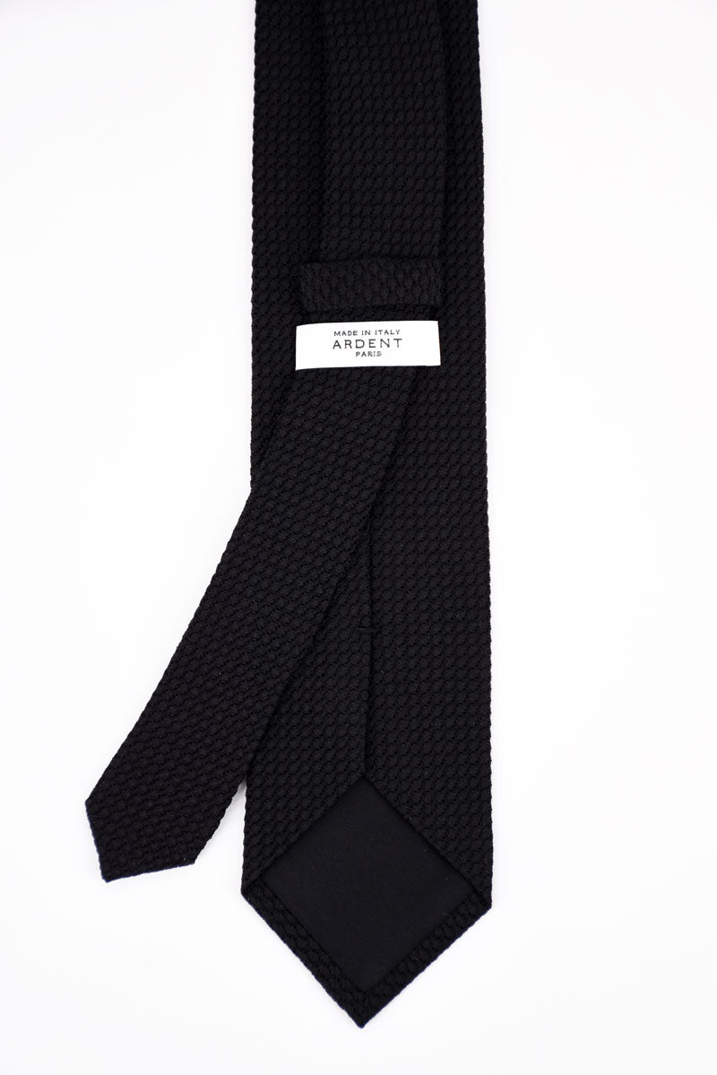 Black silk grenadine tie by Ardentes Clipei, double-layered, showcasing fine textile texture and elegant knot.