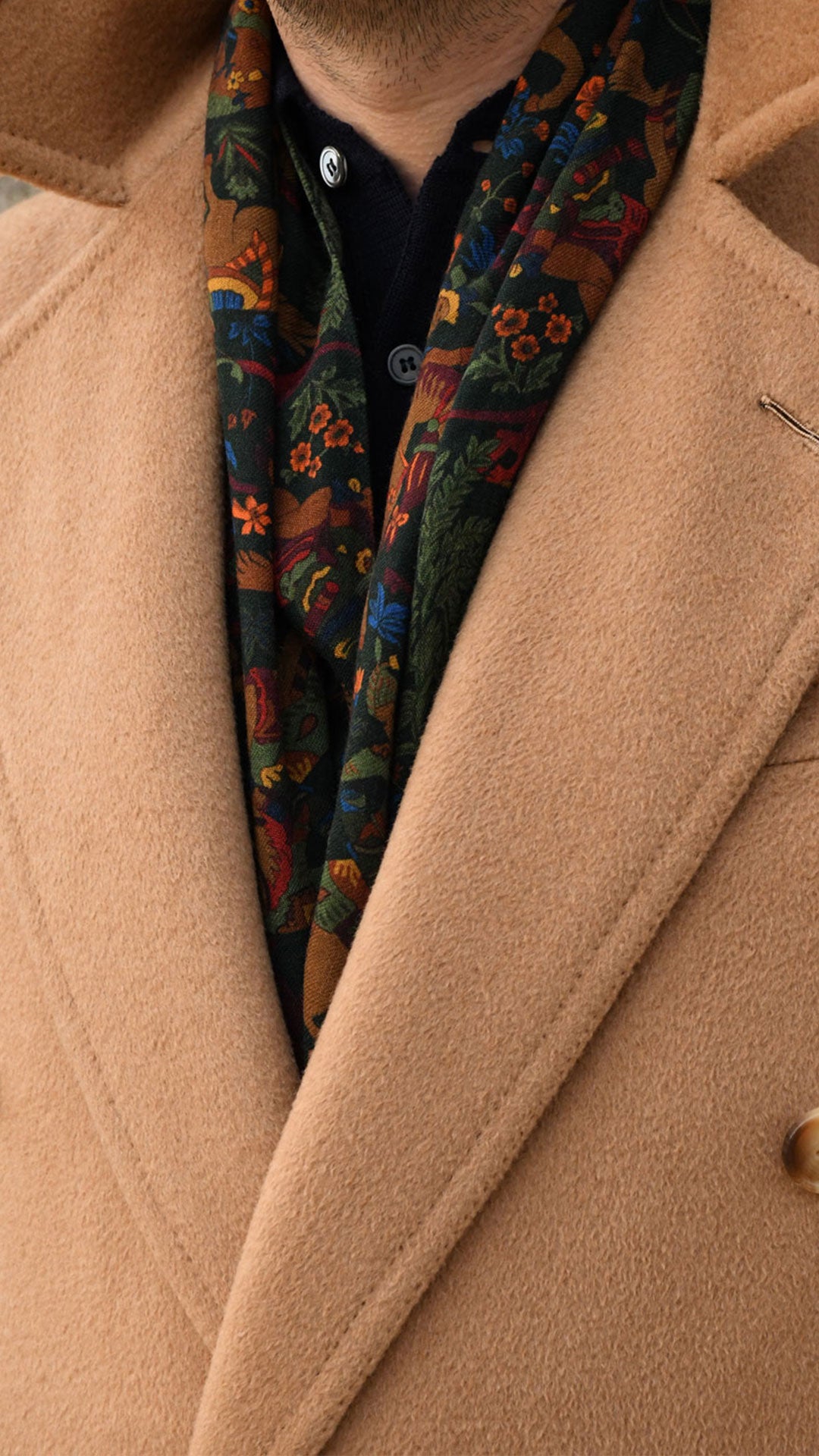 Green scarf with Mongolian hunter motif from Ardentes Clipei, showcasing intricate patterns and vibrant fabric.