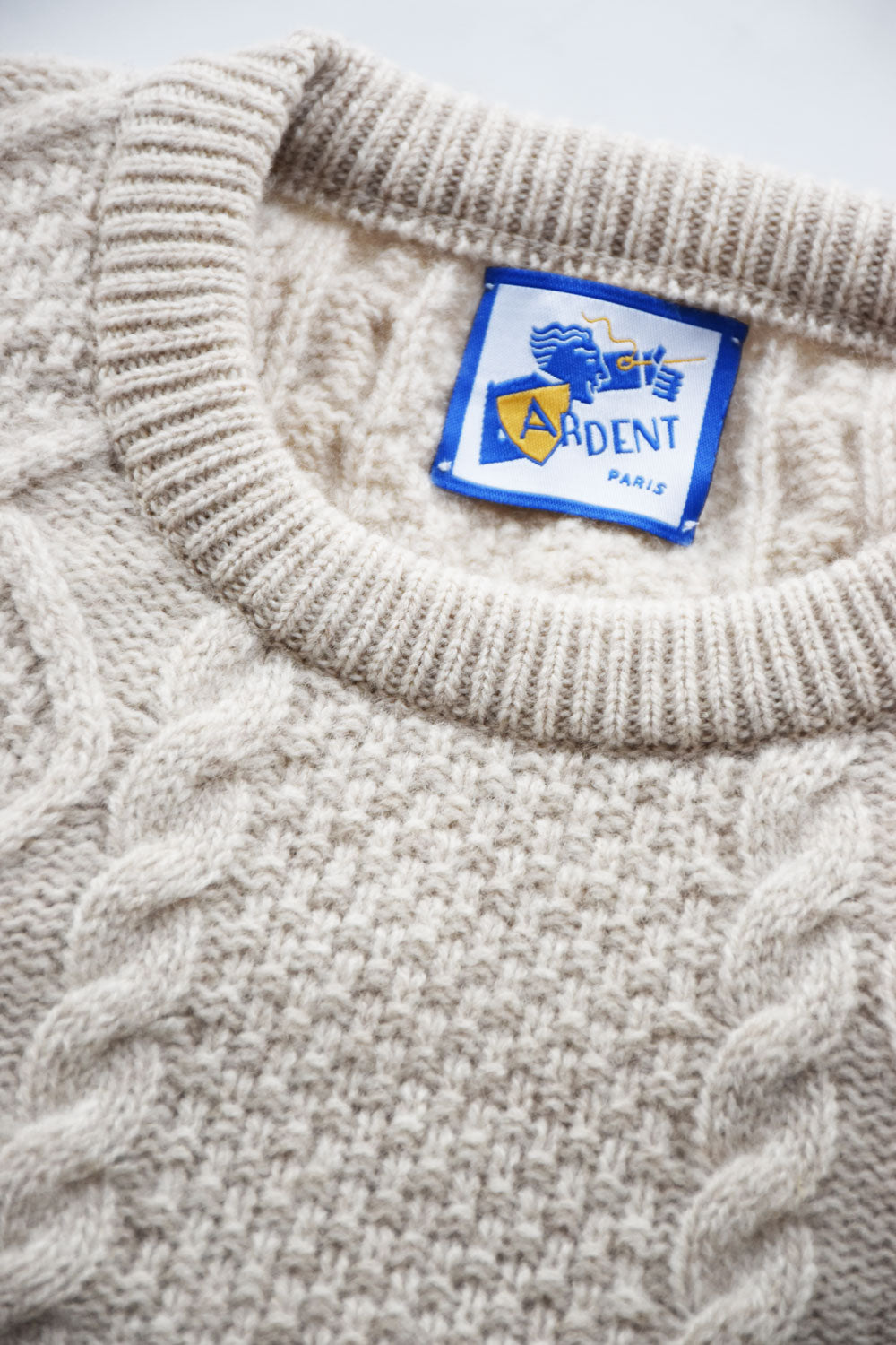 Beige Torsadé Lambswool Knit Sweater by Ardentes Clipei, showcasing textured knit pattern and soft wool fabric.