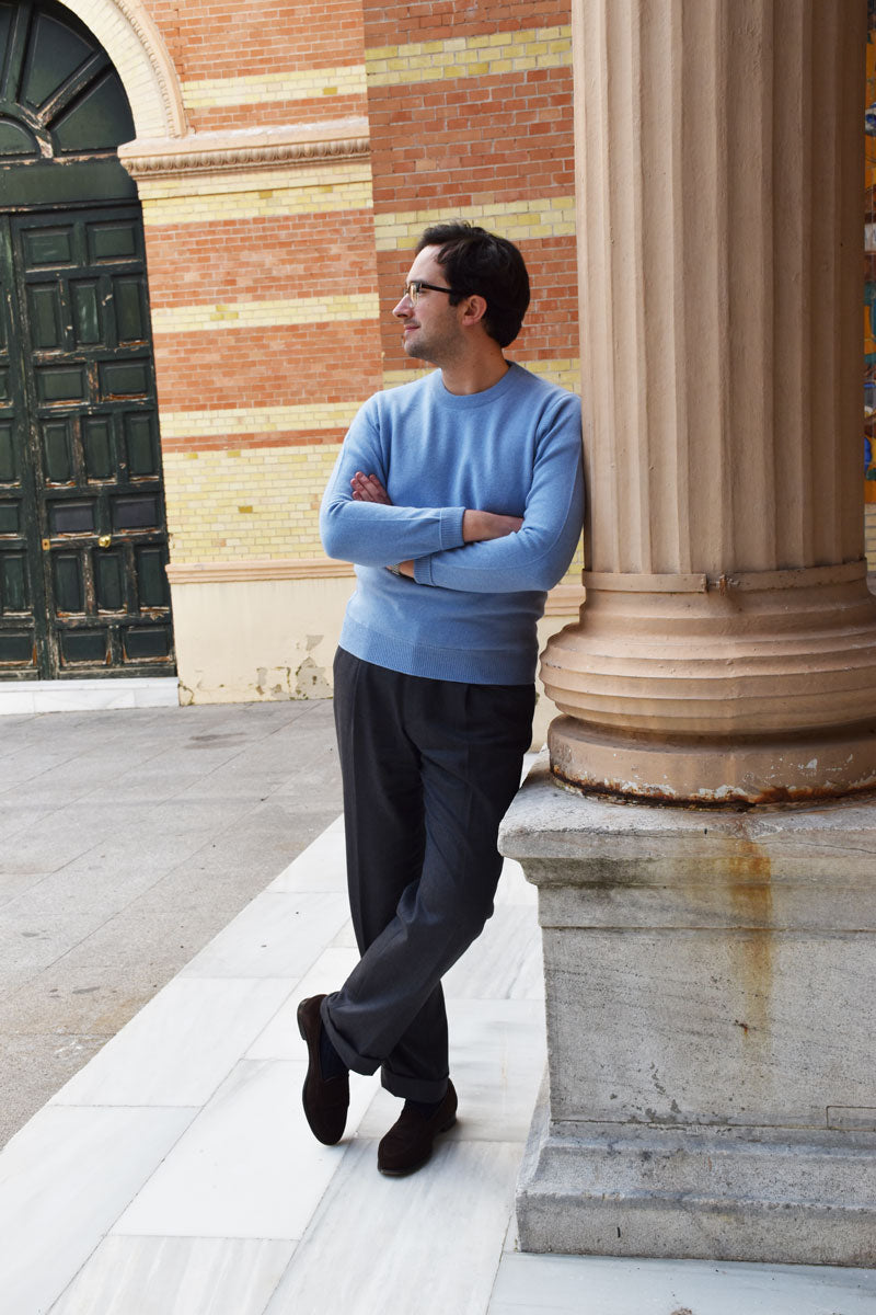 Light blue round-neck lambswool knit sweater by Ardentes Clipei, showing the textured fabric and classic fit.
