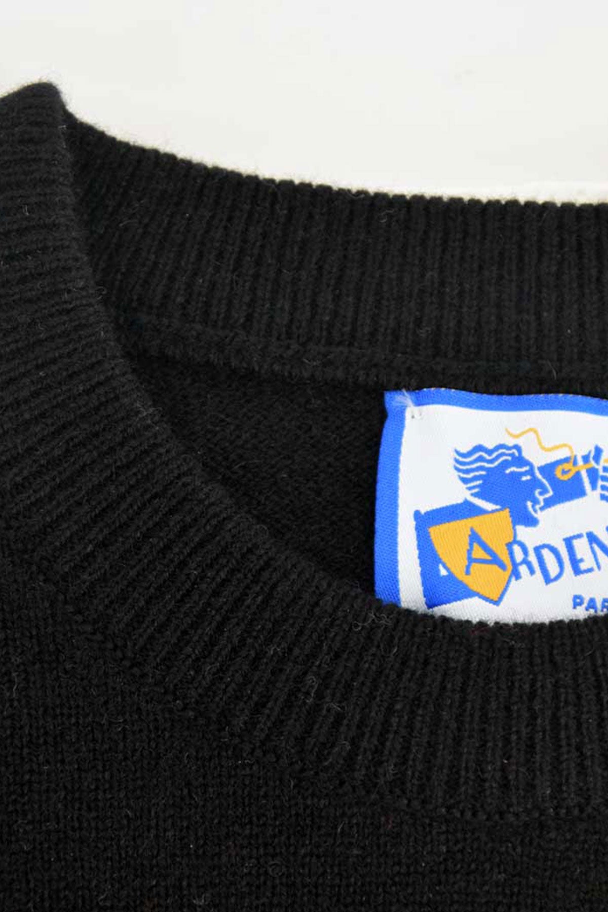Black wool crew neck sweater by Ardentes Clipei, featuring a close-fitting round collar and soft lamb’s wool material.