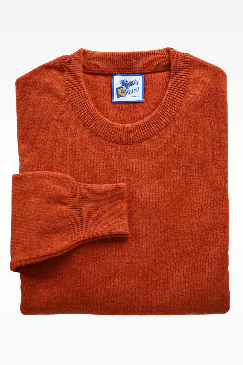 Orange wool round-neck sweater by Ardentes Clipei, lightweight knit, close-up of soft wool texture and vibrant color.