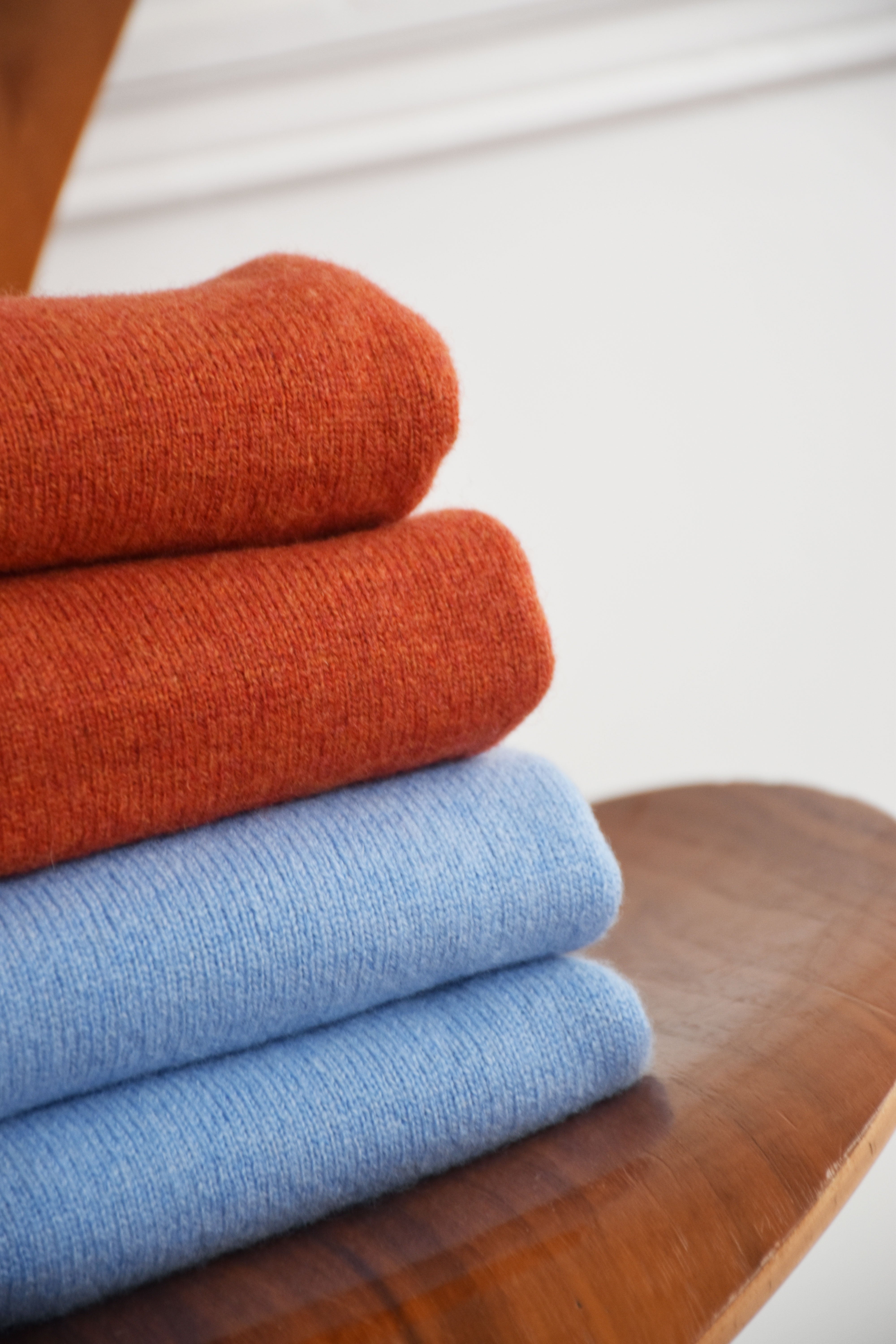 Orange wool round neck sweater by Ardentes Clipei, lightweight knit with a cozy, soft texture, shown on a plain background.