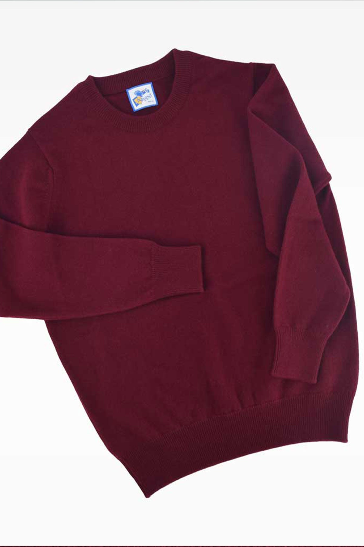 Red lambswool round neck knit sweater by Ardentes Clipei, featuring a close-up of the textured wool fabric.