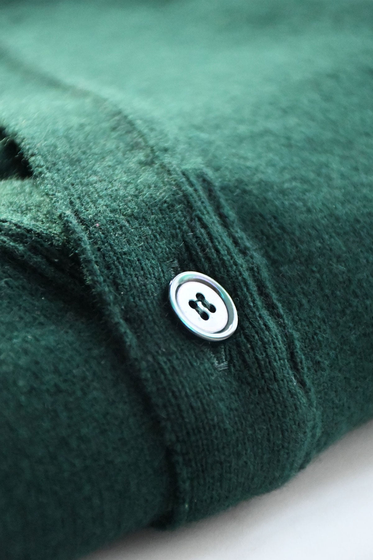 Light green wool cardigan by Ardentes Clipei, featuring a cozy knit design, perfect for casual wear and layering.