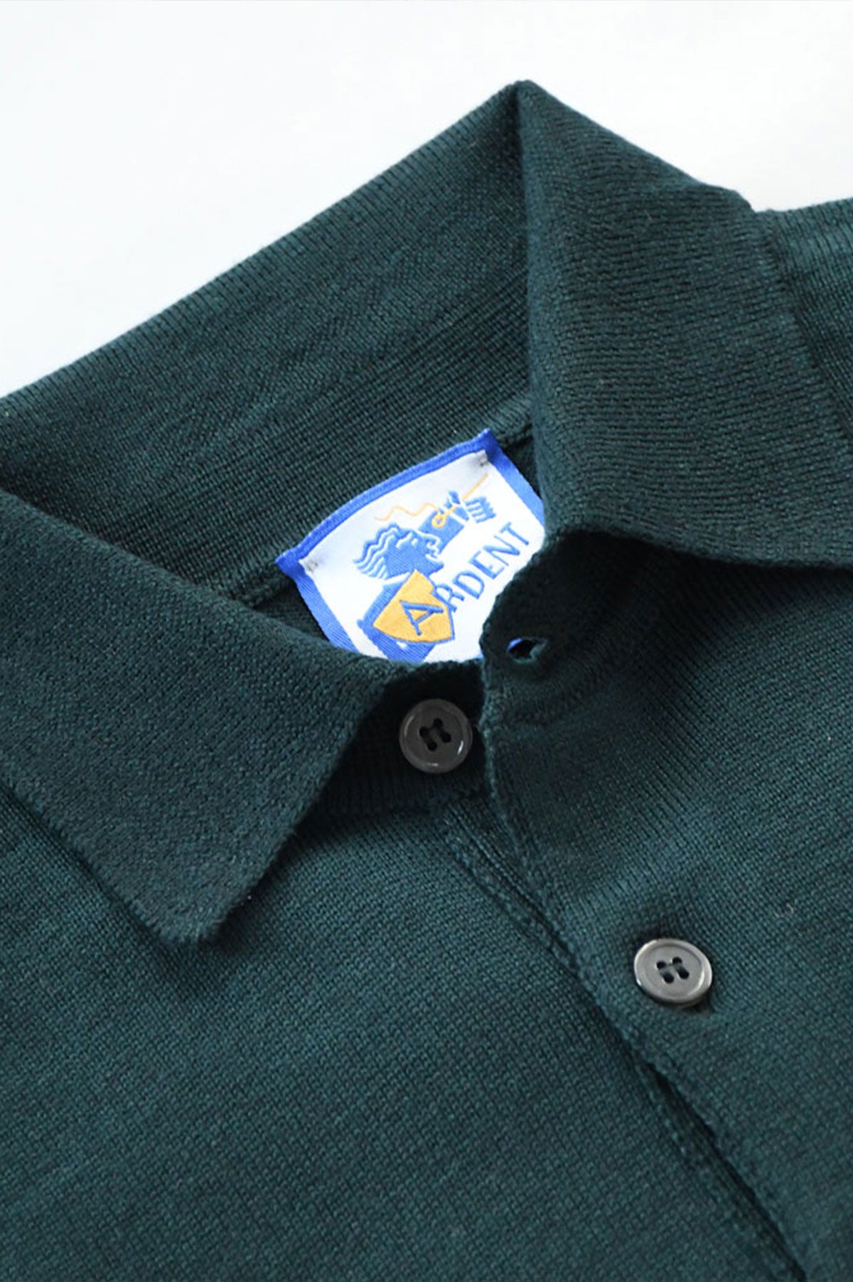 Green merino wool polo collar sweater by Ardentes Clipei, featuring a classic knit design suitable for casual or smart attire.