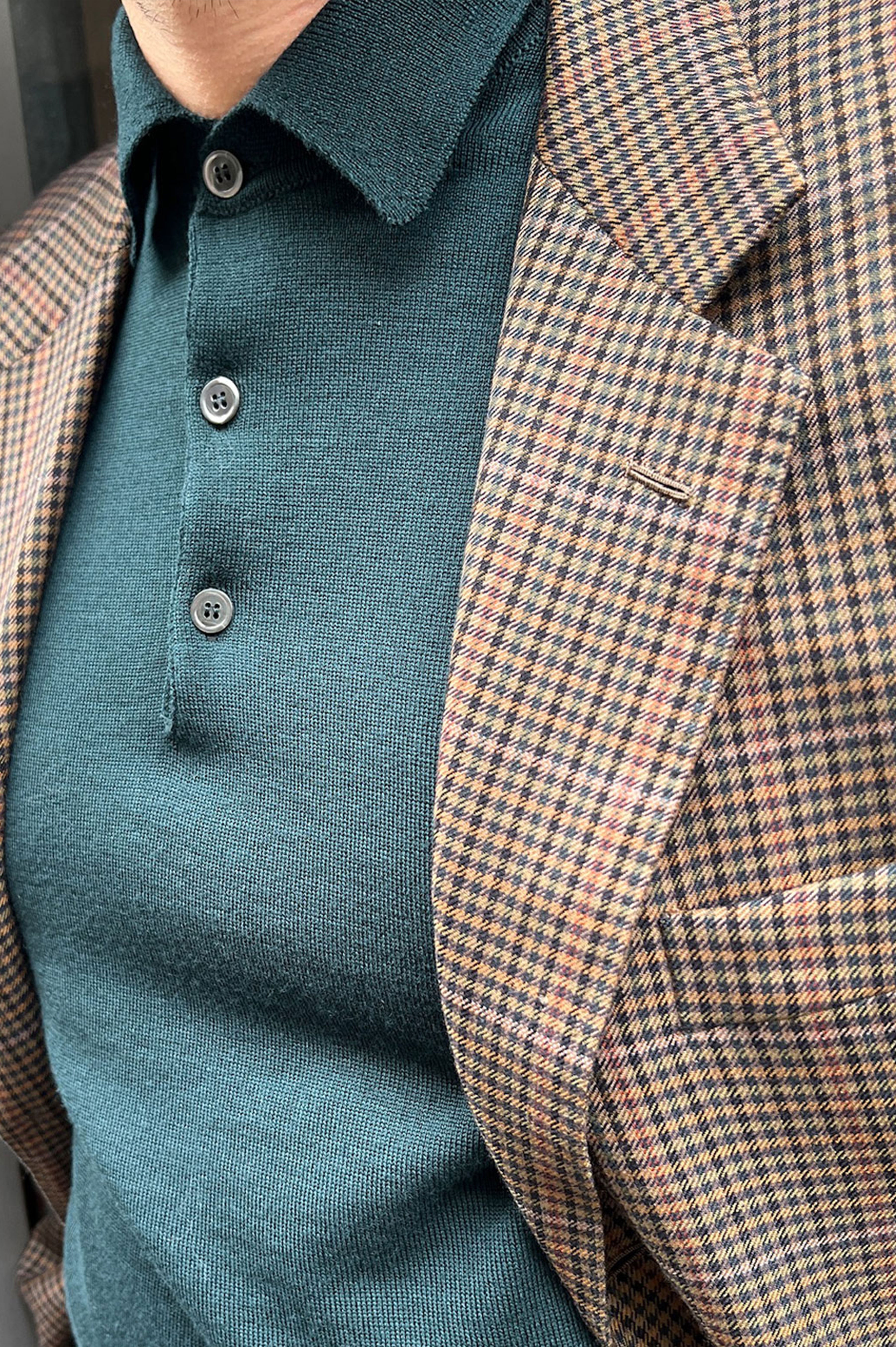 Green merino wool polo neck sweater by Ardentes Clipei, featuring a classic collar and slim fit, made from soft, high-quality wool.