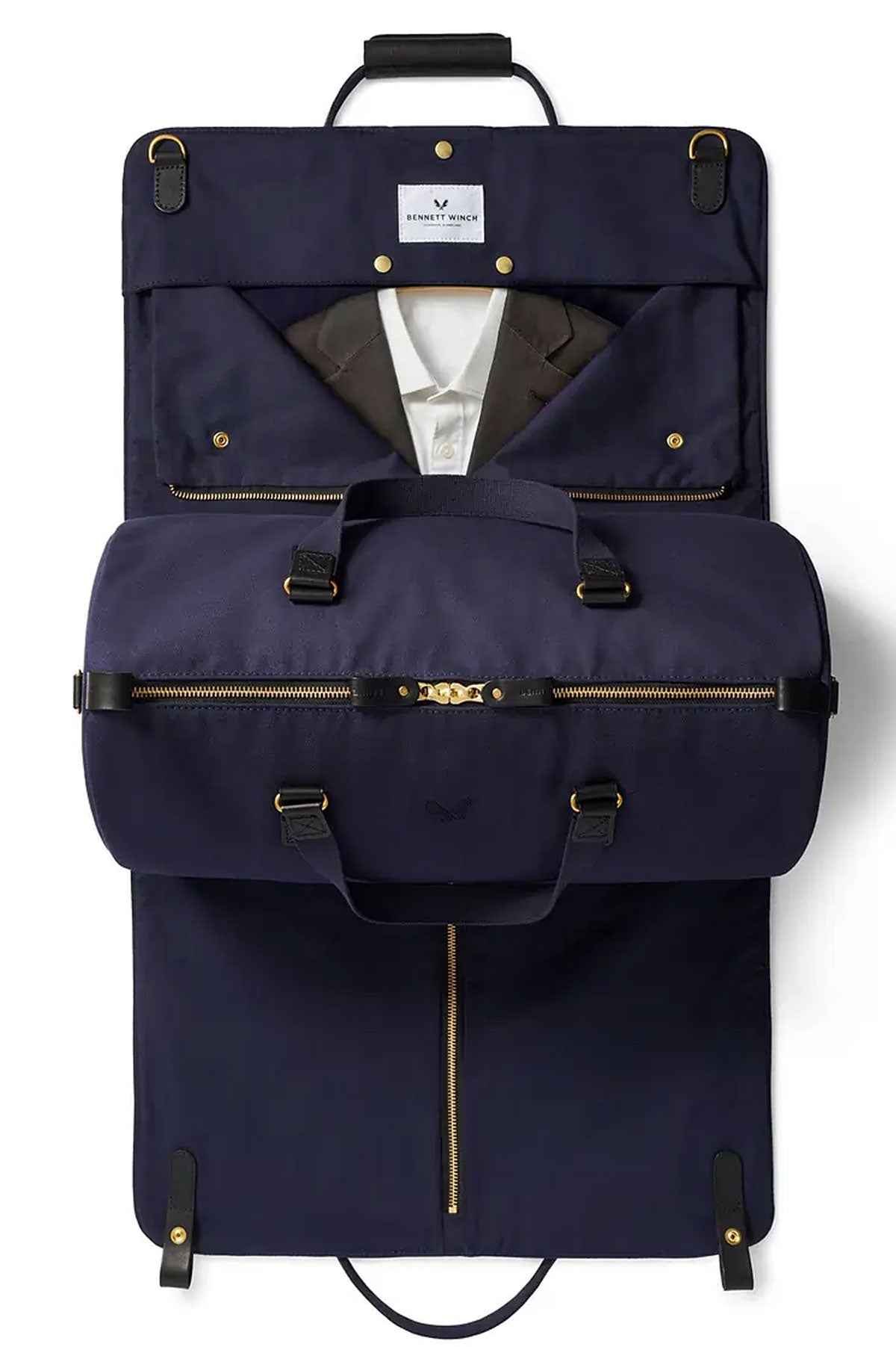 Blue marine Bennett Winch suit carrier holdall in navy leather, designed for carrying and protecting suits and formal wear.