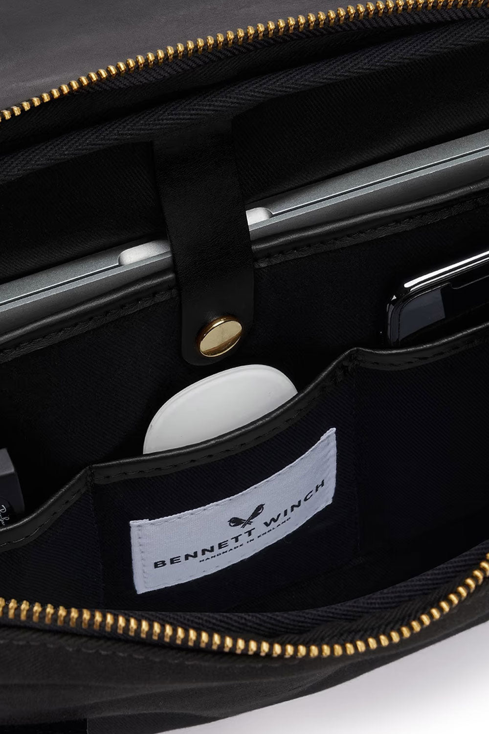 Black Bennett Winch briefcase from Ardentes Clipei, featuring sleek leather maroquinerie with sturdy handles and elegant design.