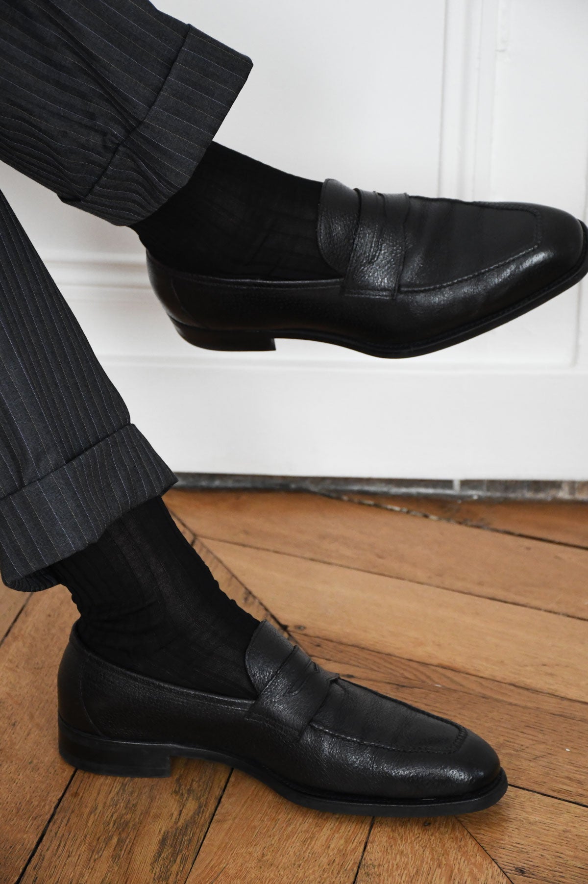 Pair of black mi-bas socks from Ardentes Clipei, showcasing their sleek, mid-calf length and smooth fabric texture.
