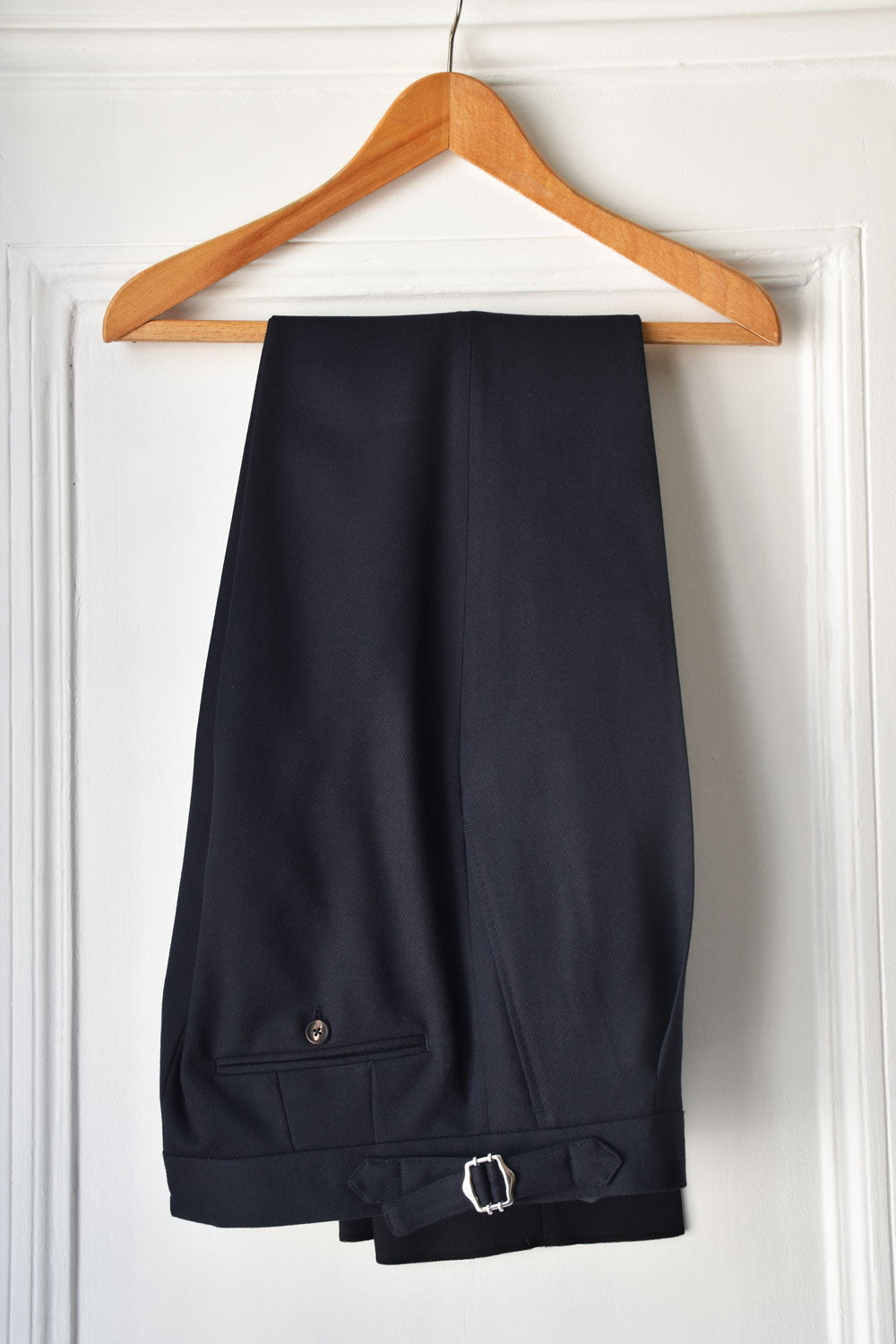 Navy blue Ardentes Clipei Cavalry Twill pants displayed on a model, showing the tailored fit and fabric texture.