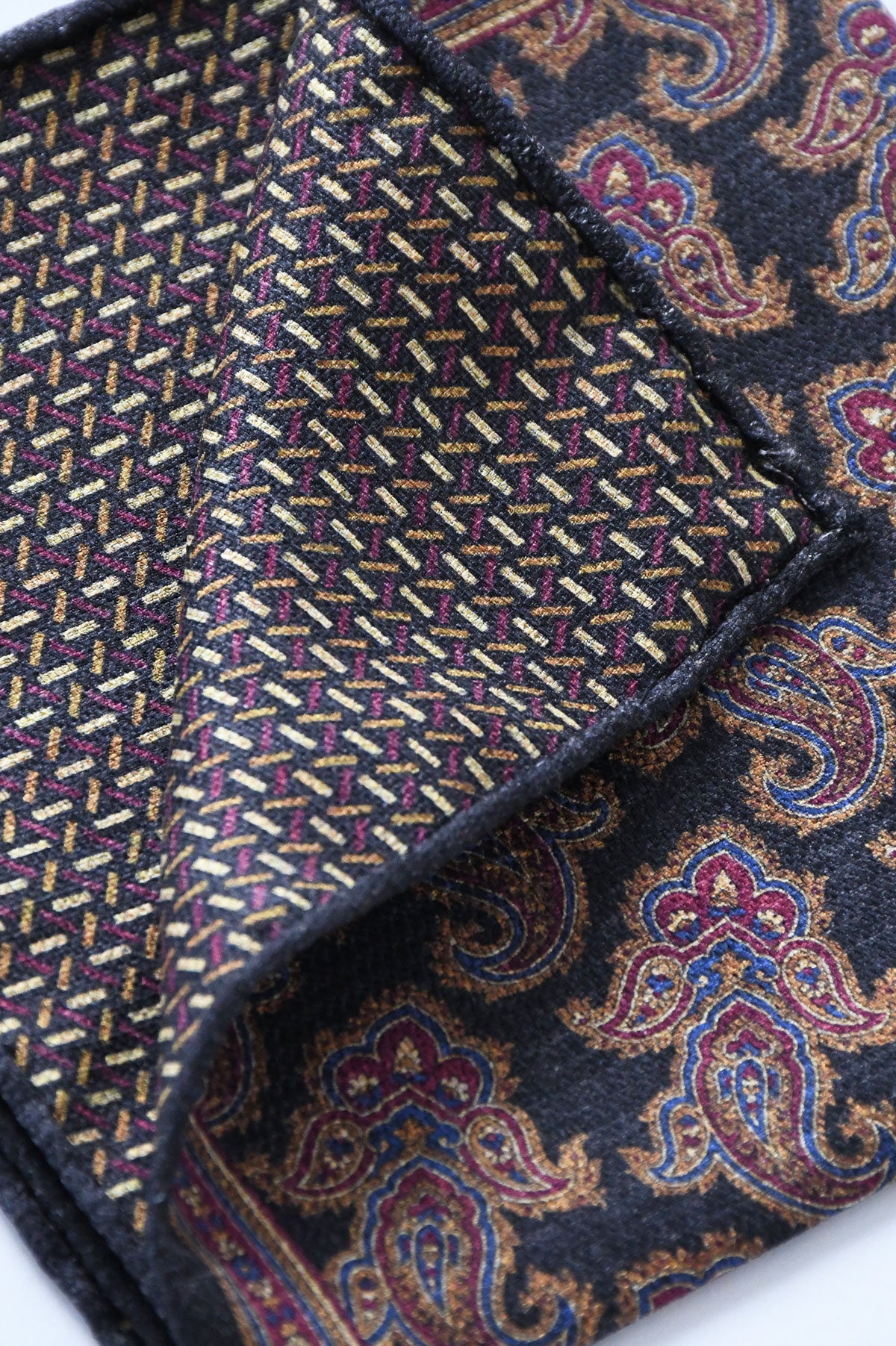 Reversible blue navy paisley motif pochette by Ardentes Clipei, showcasing elegant fabric and detailed pattern.